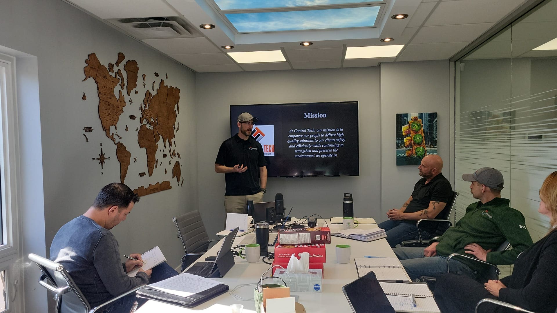 Trainer presenting a mission slide to engaged participants in a modern boardroom, representing professional development and ROI-focused leadership training.