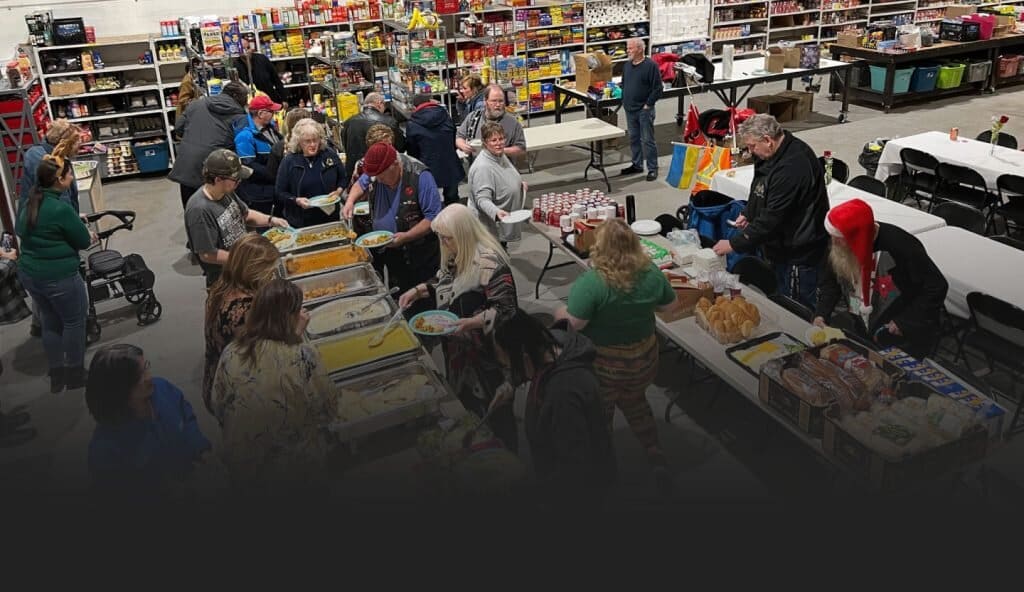 Volunteers serving a community meal at a Veterans food bank, demonstrating All Around Performance’s commitment to supporting Canadian Veterans.